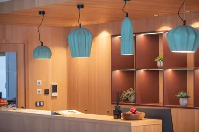 a lobby with blue pendant lights above a counter at Linara Mountain Family Stay in Valles