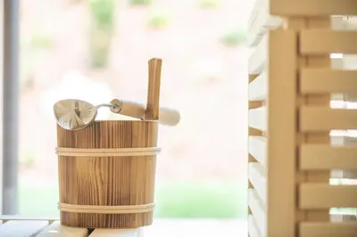 a wooden candle holder on a table next to a window at Linara Mountain Family Stay in Valles