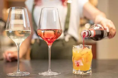 two glasses of wine sitting on a table at Linara Mountain Family Stay in Valles