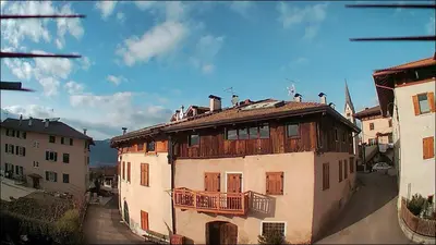 an old building with a balcony on top of it at Casa Vacanze Fontana in Coredo