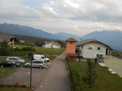 a street with cars parked in a parking lot at Casa Vacanze Fontana in Coredo