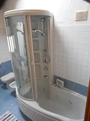 a shower stall in a bathroom with a tub at Casa Vacanze Fontana in Coredo