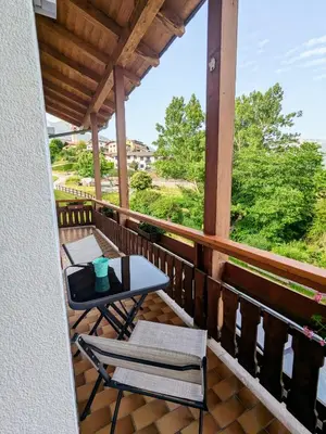 a balcony with two chairs and a table and a view at Casa Lagoraiview in Carano