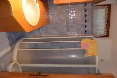 a kitchen counter with a sink and a towel at Villa Ronco - Stayincortina in Cortina dʼAmpezzo