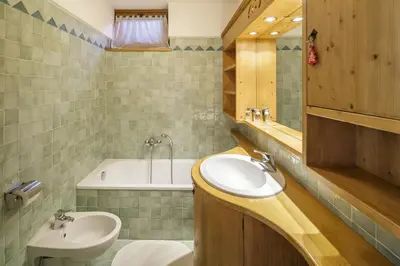 a bathroom with a sink and a bath tub at Villa Ronco - Stayincortina in Cortina dʼAmpezzo