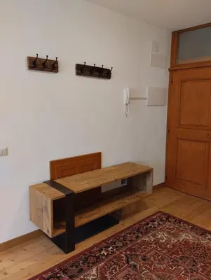a wooden table in a room next to a door at Villa Ronco - Stayincortina in Cortina dʼAmpezzo