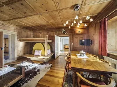 a room with a table and a bunk bed at Villa Ronco - Stayincortina in Cortina dʼAmpezzo