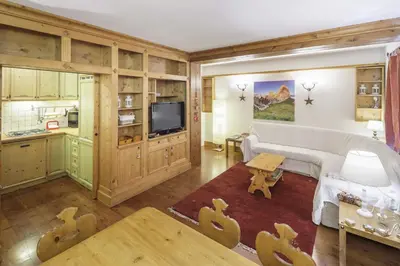 a living room with a couch and a table at Villa Ronco - Stayincortina in Cortina dʼAmpezzo