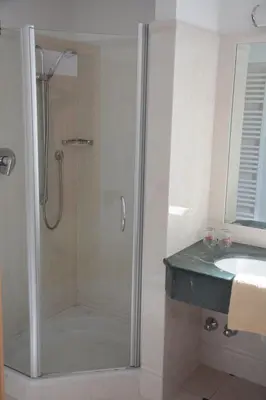 a bathroom with a shower and a sink at Hotel Tannerhof in Schenna