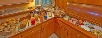 a counter with a lot of food on it at Hotel Tannerhof in Schenna