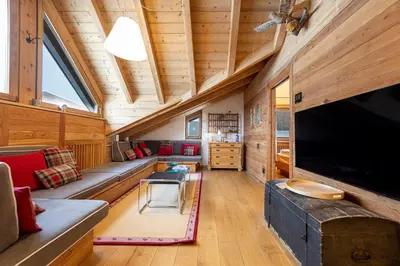 a living room with a large flat screen tv at Attic Apartment Dolasilla in Selva di Val Gardena