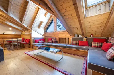 a living room with a couch and a table at Attic Apartment Dolasilla in Selva di Val Gardena