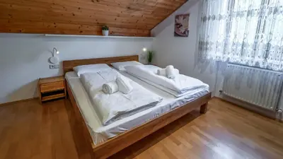 a bedroom with a bed with white sheets and pillows at Ferienwohnung Bergblick in Termeno