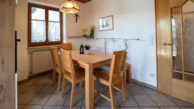 a dining room with a wooden table and chairs at Ferienwohnung Bergblick in Termeno
