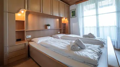 a bedroom with two beds and a window at Ferienwohnung Bergblick in Termeno