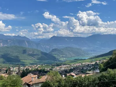 a town in a valley with mountains in the background at Weißhaus Hof in Caldaro
