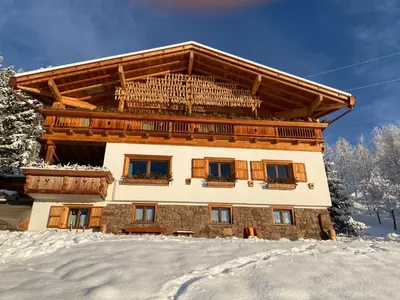 a building in the snow with snow at B&B Belvedere in Daiano