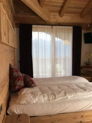 a bed in a room with a window at B&B Belvedere in Daiano
