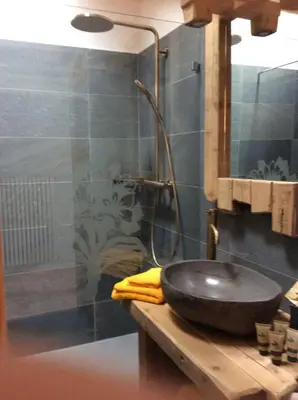 a bathroom with a black sink and a shower at B&B Belvedere in Daiano