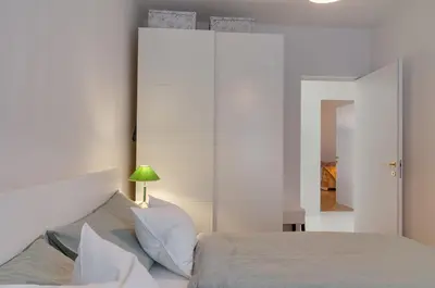 a bedroom with a bed and a green lamp at Frida's apartment in Merano
