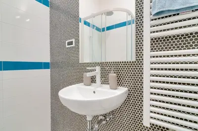 a bathroom with a sink and a mirror at Frida's apartment in Merano