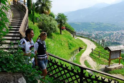 a man and woman standing on a hill with a view at Hotel Restaurant Waldea in Marlengo
