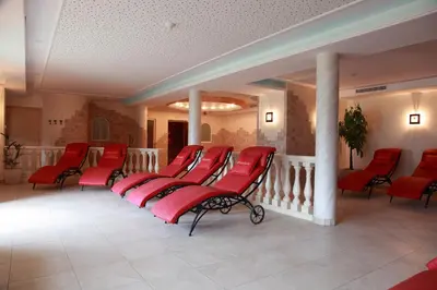a row of red chairs in a waiting room at Hotel Restaurant Waldea in Marlengo