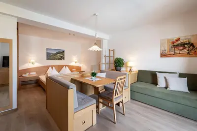 a living room with a couch and a table at Hotel Restaurant Waldea in Marlengo