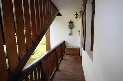 a hallway with a wooden stairway with a wooden box at Appartamento Croda in Cortina dʼAmpezzo