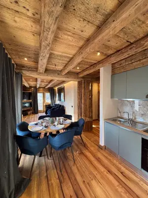 a kitchen and dining room with a table and chairs at Luxury Central Apartment Cortina D'Ampezzo in Cortina dʼAmpezzo