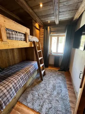 a bedroom with two bunk beds in a cabin at Luxury Central Apartment Cortina D'Ampezzo in Cortina dʼAmpezzo