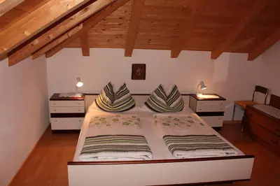 a bed with two pillows on it in a room at FeWo 3 am Martinshof in Eppan im Süden Südtirols in Missiano