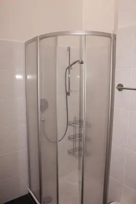 a shower with a glass door in a bathroom at FeWo 3 am Martinshof in Eppan im Süden Südtirols in Missiano