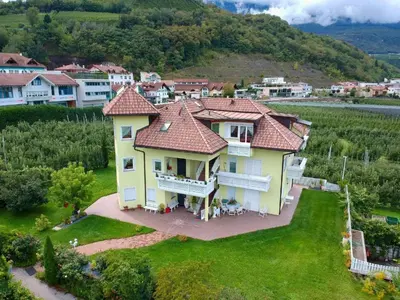 a large yellow house with a red roof at FeWo 3 am Martinshof in Eppan im Süden Südtirols in Missiano