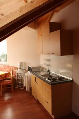 a kitchen with a sink and a stove at FeWo 2 am Martinshof in Eppan im Süden Südtirols in Missiano