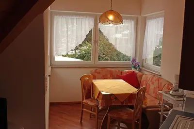 a living room with a table and a couch at FeWo 2 am Martinshof in Eppan im Süden Südtirols in Missiano