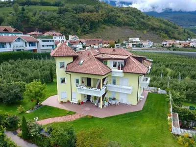 an aerial view of a large house on a lawn at FeWo 2 am Martinshof in Eppan im Süden Südtirols in Missiano
