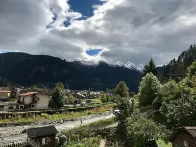 a view of a town with mountains in the background at Appartamento nelle Dolomiti 900 mt dallo stadio del salto in Predazzo