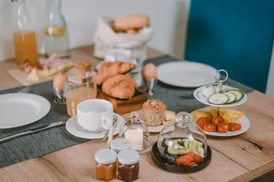 a table with plates of food on a table at Luisashaus in Tirolo