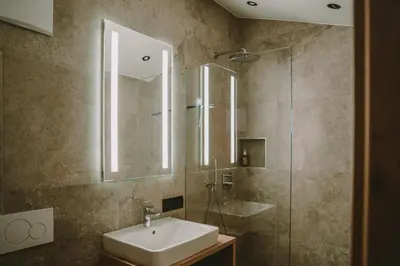 a bathroom with a sink and a shower at Luisashaus in Tirolo