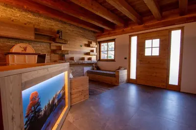 a living room with a large flat screen tv in a log cabin at Mas di Siti in Castelfondo