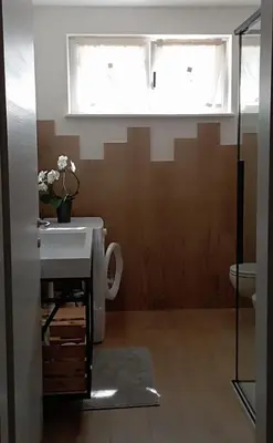 a bathroom with a sink and a toilet and a window at Grande appartamento indipendente in Coredo
