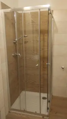 a shower with glass doors in a bathroom at Grande appartamento indipendente in Coredo