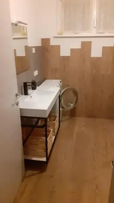 a bathroom with a sink and a toilet at Grande appartamento indipendente in Coredo