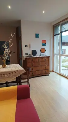 a living room with a table and a dresser at Apartment Rosanna Val di Non, Sanzeno in Sanzeno
