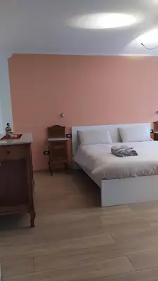 a bedroom with a white bed and a table at Apartment Rosanna Val di Non, Sanzeno in Sanzeno