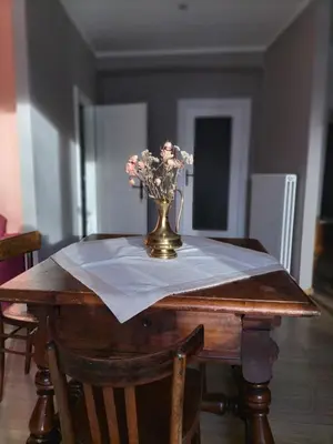 a table with a vase of flowers on top of it at Apartment Rosanna Val di Non, Sanzeno in Sanzeno