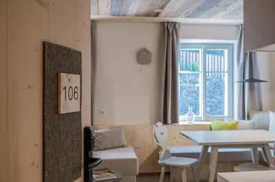a living room with a table and a dining room at Ansitz Pontegardena in Ponte Gardena