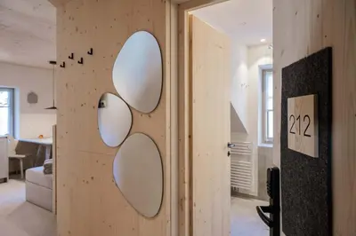 a room with three circular mirrors on the wall at Ansitz Pontegardena in Ponte Gardena