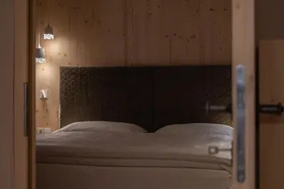 a bedroom with a large bed with white pillows at Ansitz Pontegardena in Ponte Gardena
